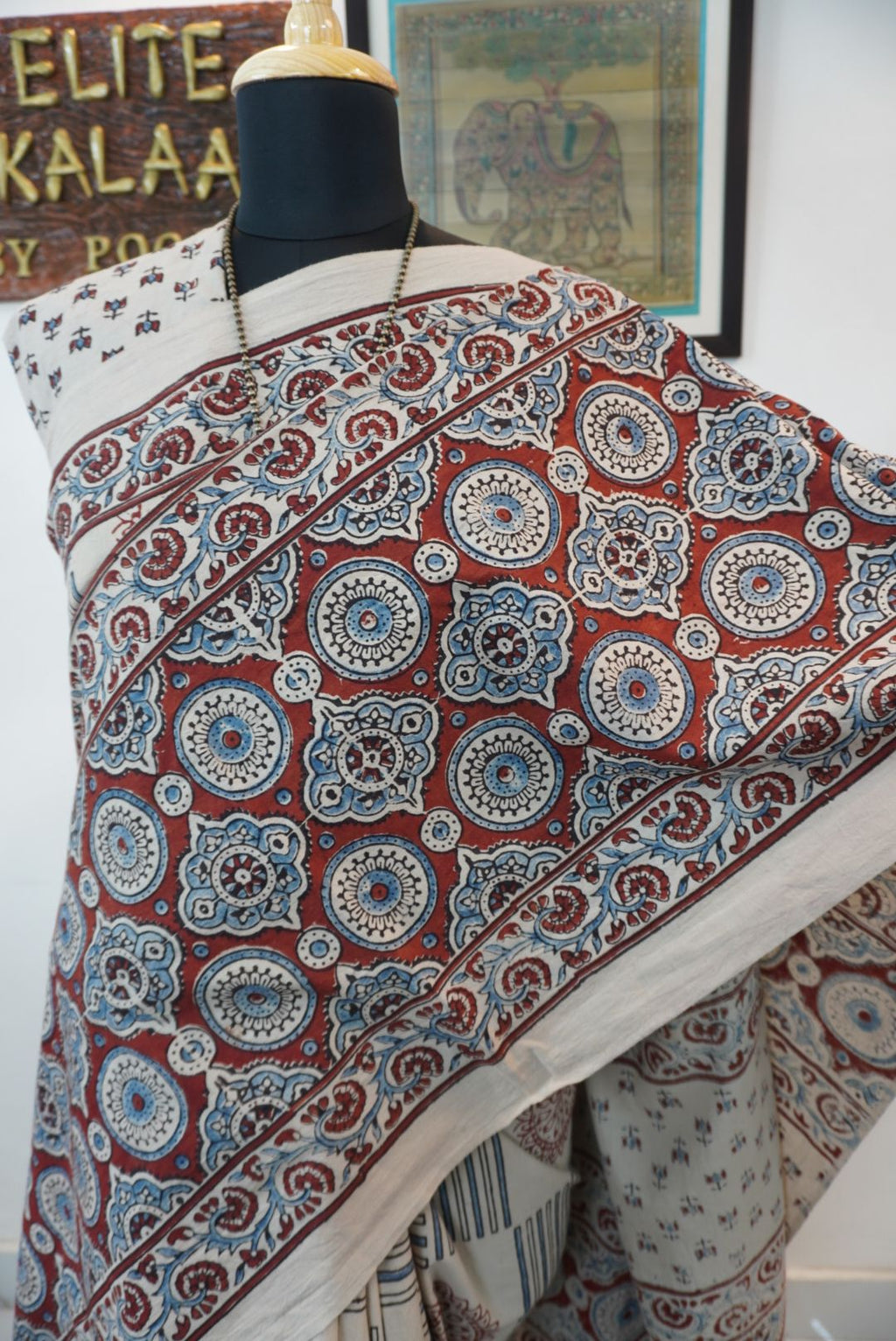 Ajrakh cotton saree in ivory with red rust and blue all-over pattern, border and tassels
