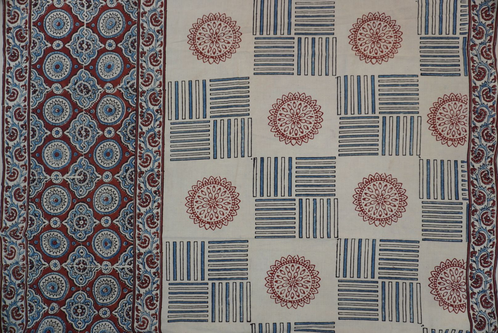 Ajrakh cotton saree in ivory with red rust and blue all-over pattern, border and tassels