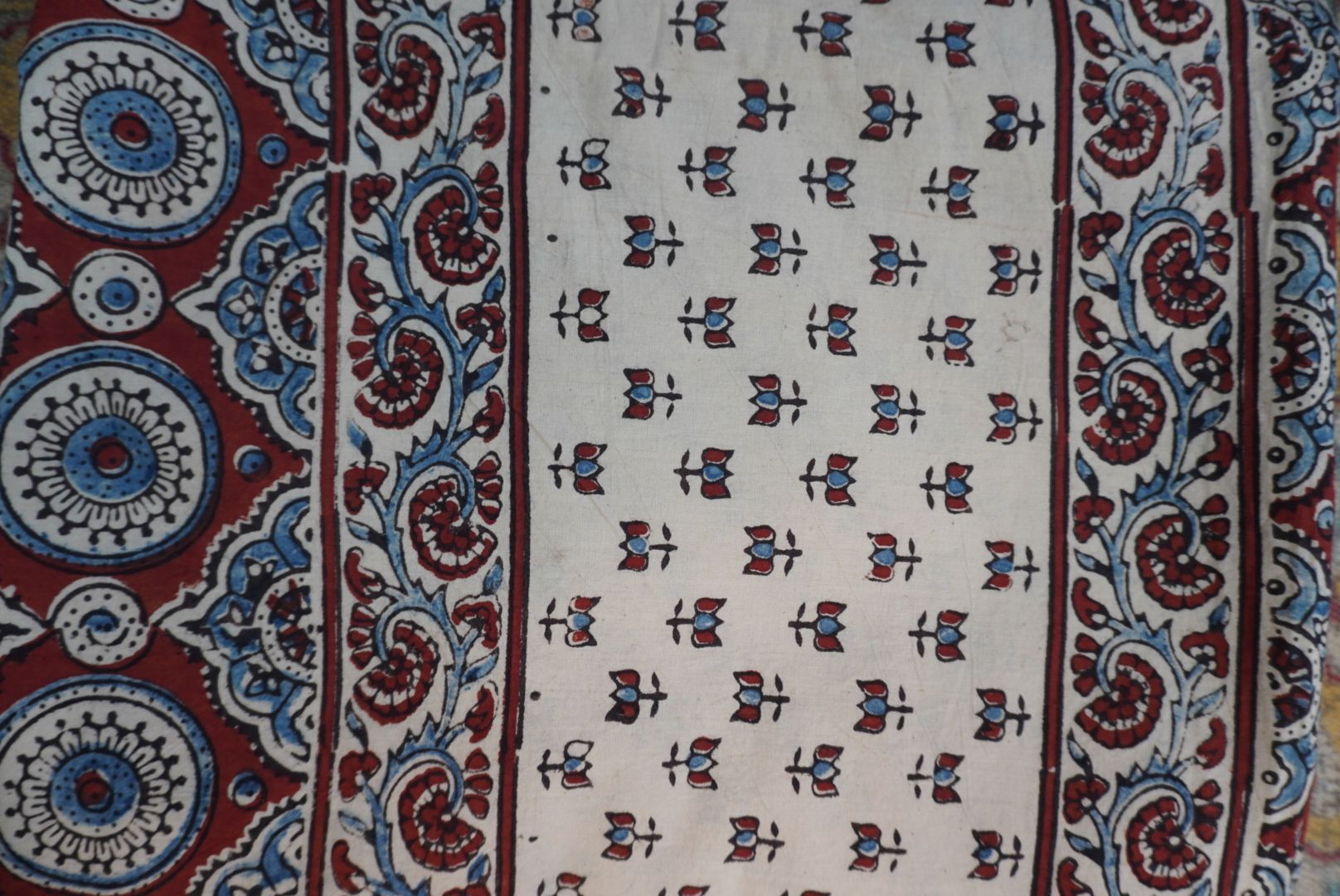 Ajrakh cotton saree in ivory with red rust and blue all-over pattern, border and tassels
