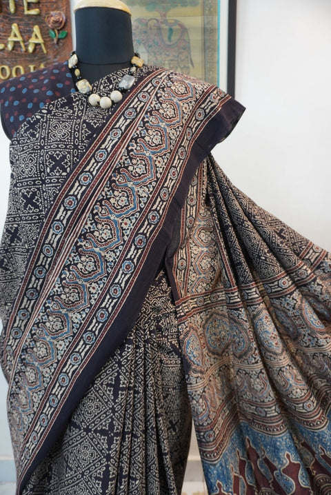 Black Ajrakh cotton saree with all-over pattern, blue beige and maroon details, and border
