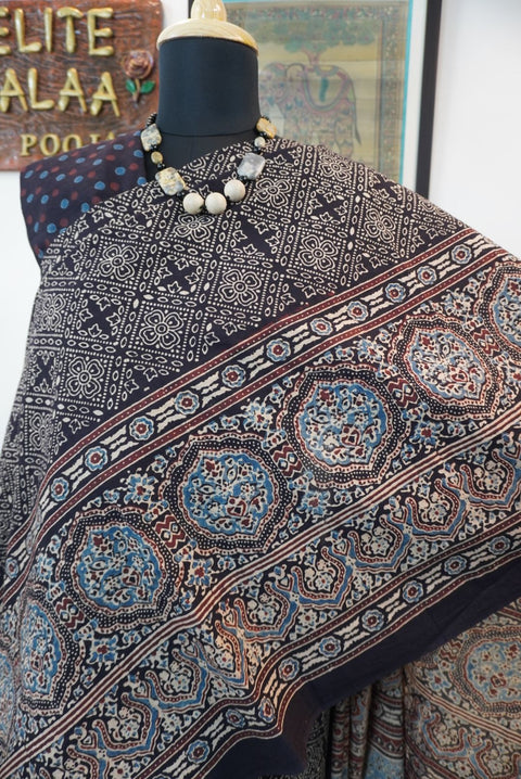 Black Ajrakh cotton saree with all-over pattern, blue beige and maroon details, and border