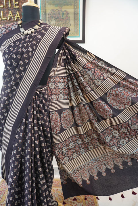 Black Ajrakh cotton saree with multicolor block print, border and tassels