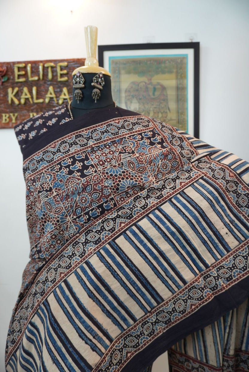 Black Ajrakh cotton saree with intricate jaal design, beige blue and maroon accents, border and tassels