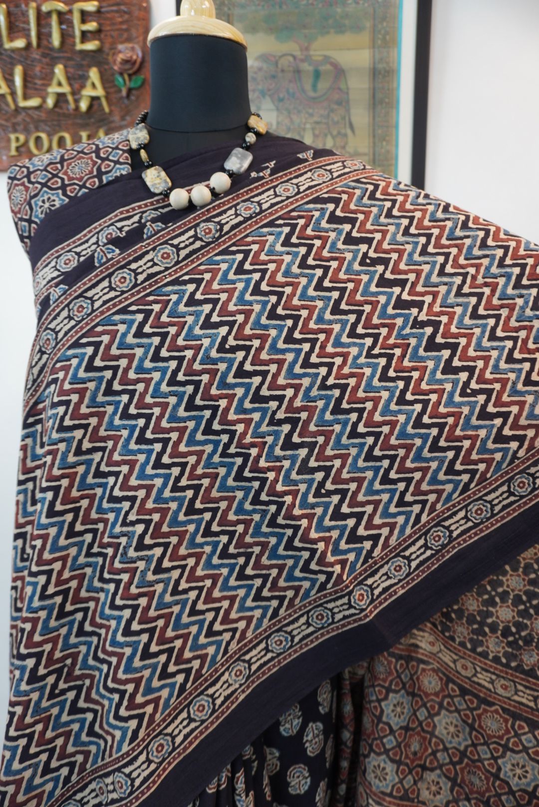 Black Ajrakh cotton saree with small flower and chevron design, border and tassels