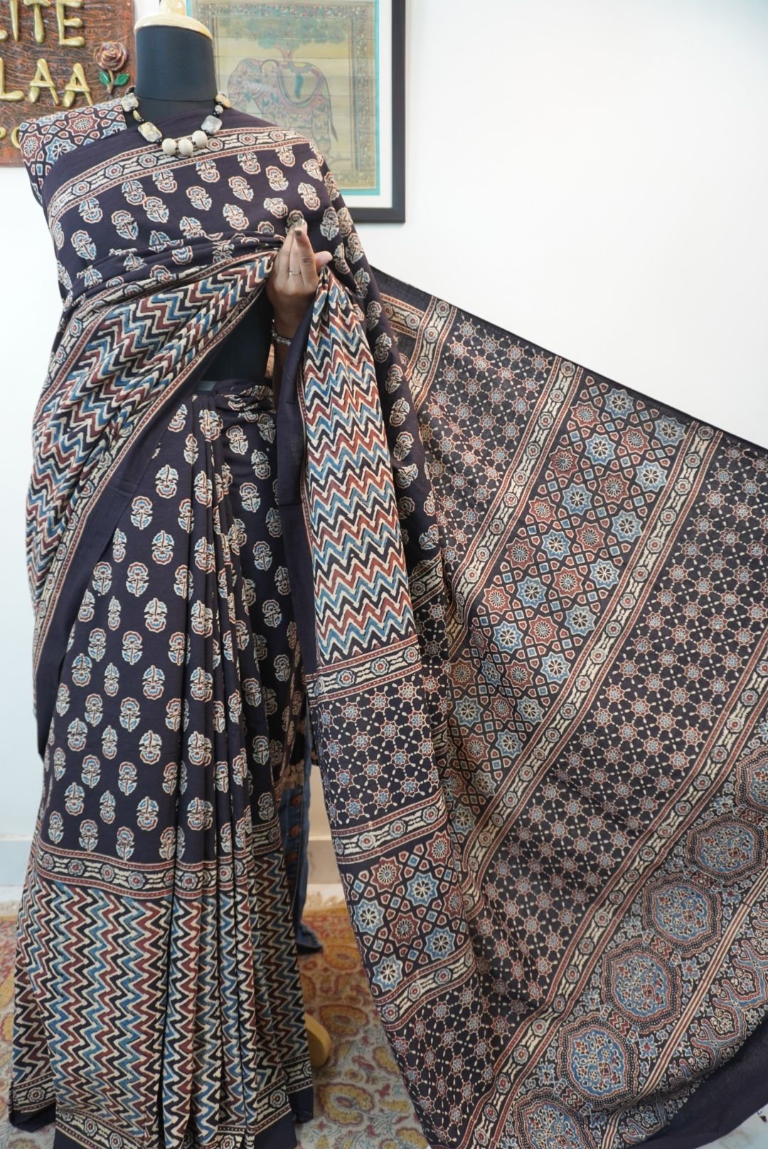 Black Ajrakh cotton saree with small flower and chevron design, border and tassels