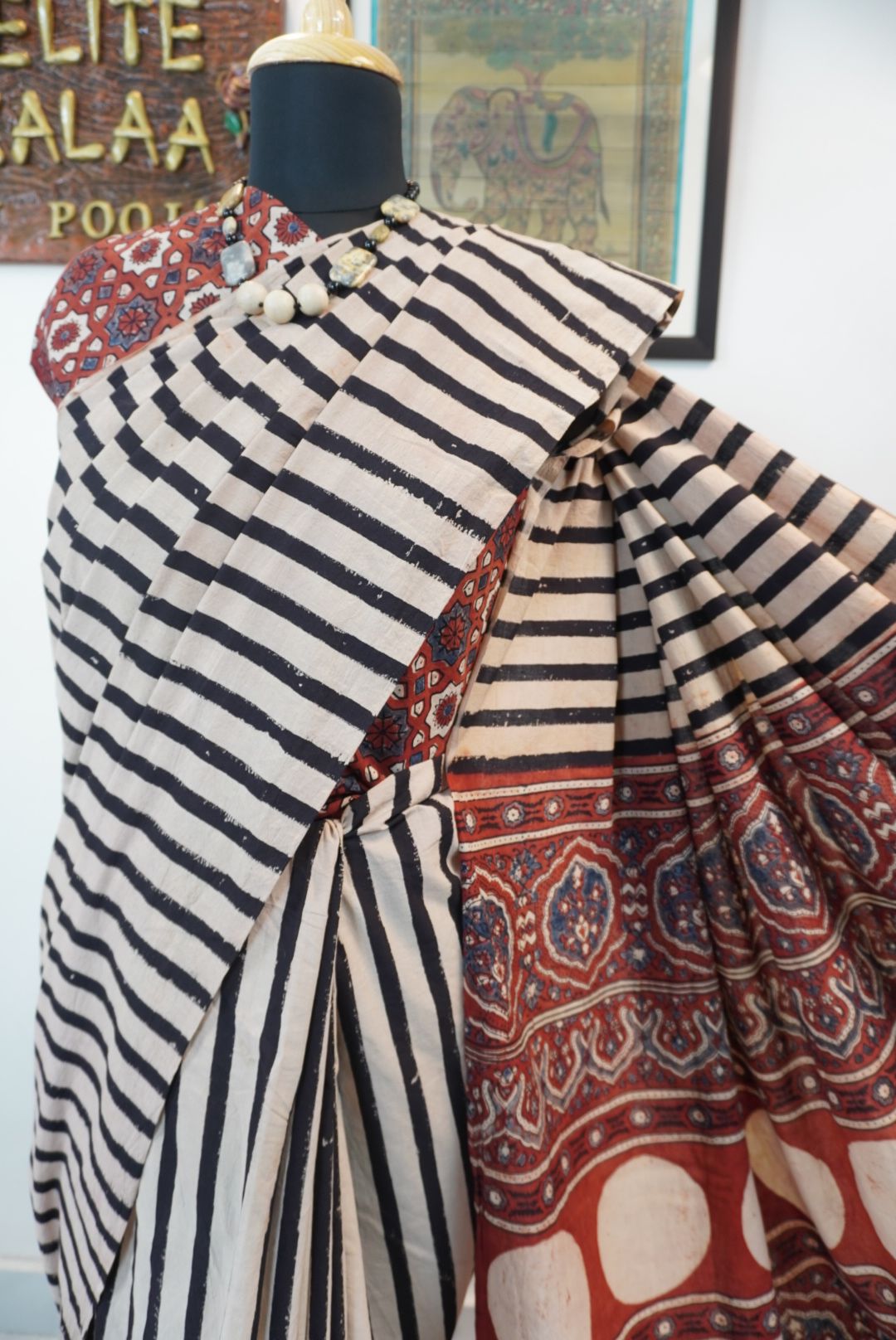 Cream Ajrakh cotton saree with red and black stripes and a border