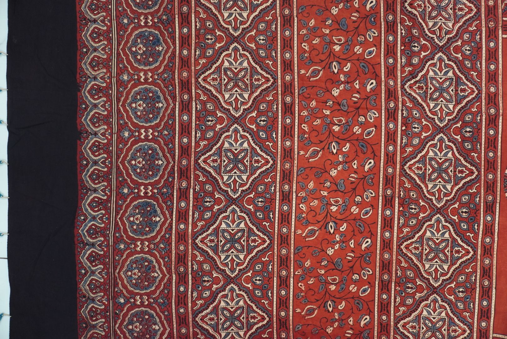 Red Ajrakh cotton saree with geometric circle design in white, blue and black
