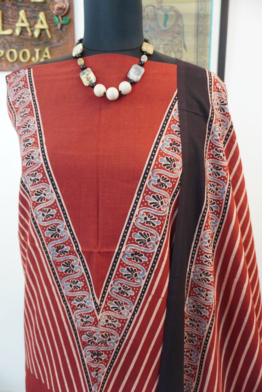 Red Ajrakh handblock kala cotton kurta fabric with black, cream and grey block pattern and border detail