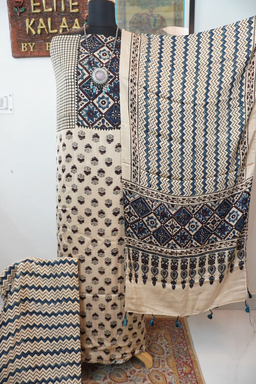 Cream Ajrakh handblock 3 piece dress material with small flower all-over design, blue and brown accents, border and tassels