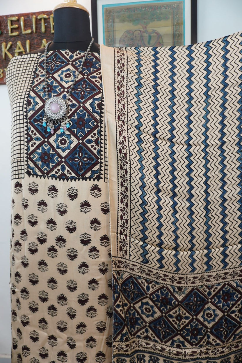 Cream Ajrakh handblock 3 piece dress material with small flower all-over design, blue and brown accents, border and tassels
