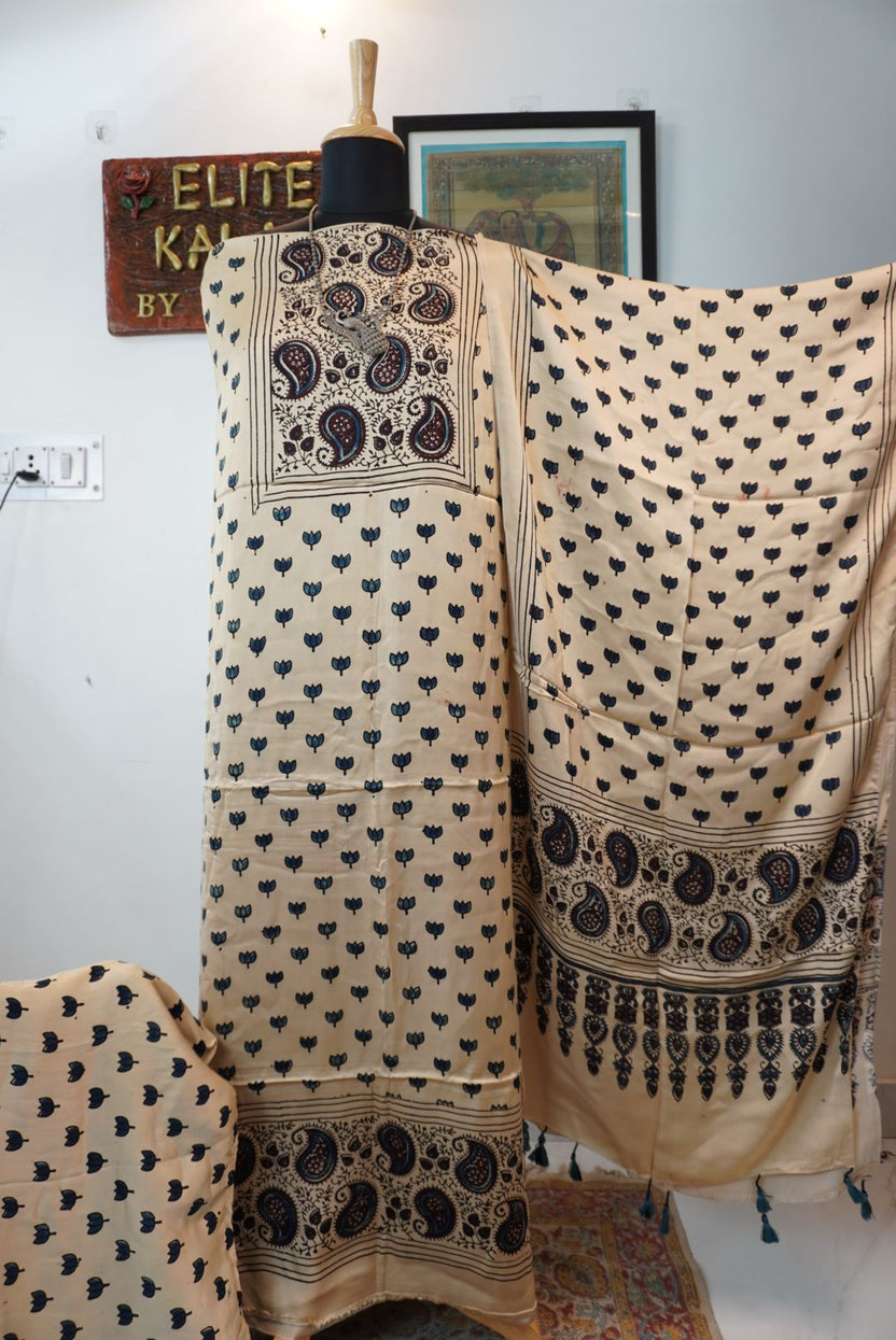 Beige 3 piece suit with stole, multicolor small lotus placement pattern, blue black and maroon details, border and tassels