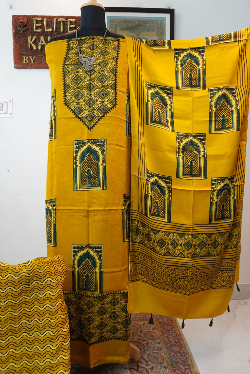 Yellow 3 piece dress material with multicolor jharokha design, border and tassels