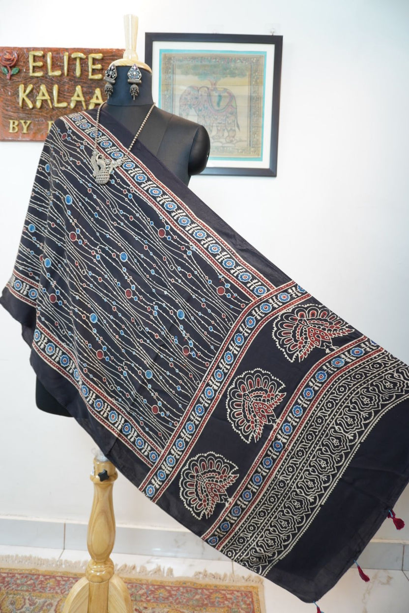 Black Ajrakh modal stole with blue, red and white all-over design, border and tassels