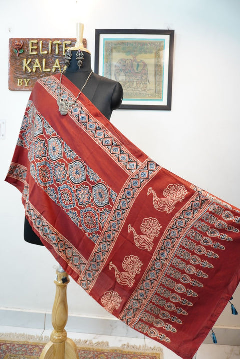 Red Ajrakh modal stole with badam boota placement pattern in beige, blue and black, with border and tassels