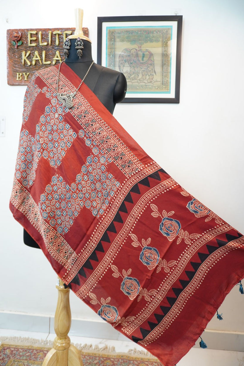 Red Ajrakh modal stole with blue, white and black all-over pattern, border and tassels