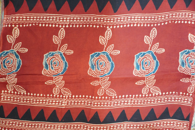Red Ajrakh modal stole with blue, white and black all-over pattern, border and tassels