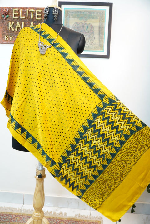 Yellow Ajrakh modal stole with green and black all-over polka dot pattern, border and tassels