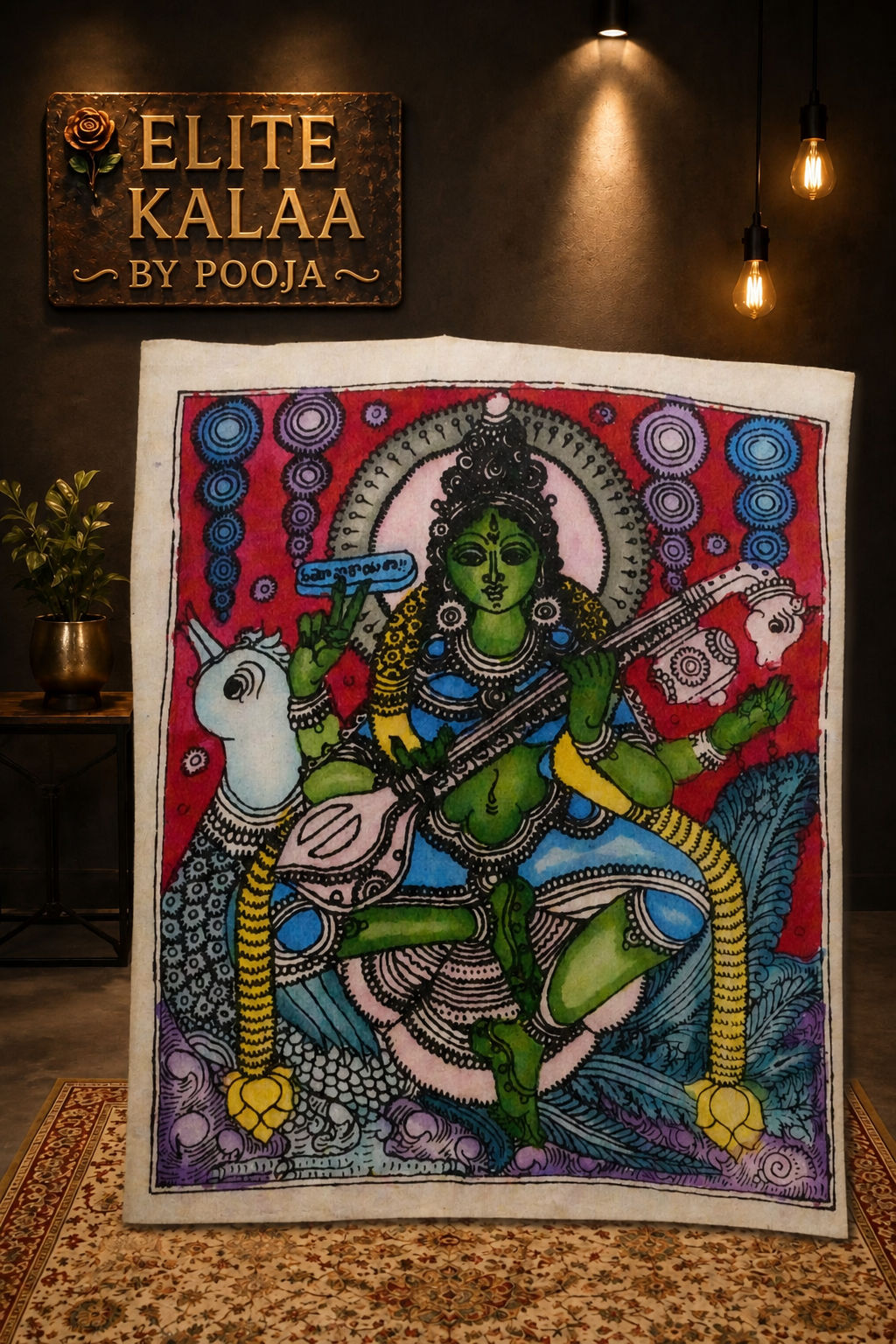 Red figurative Kalamkari patch with Saraswati and Veena design, shown with a border.