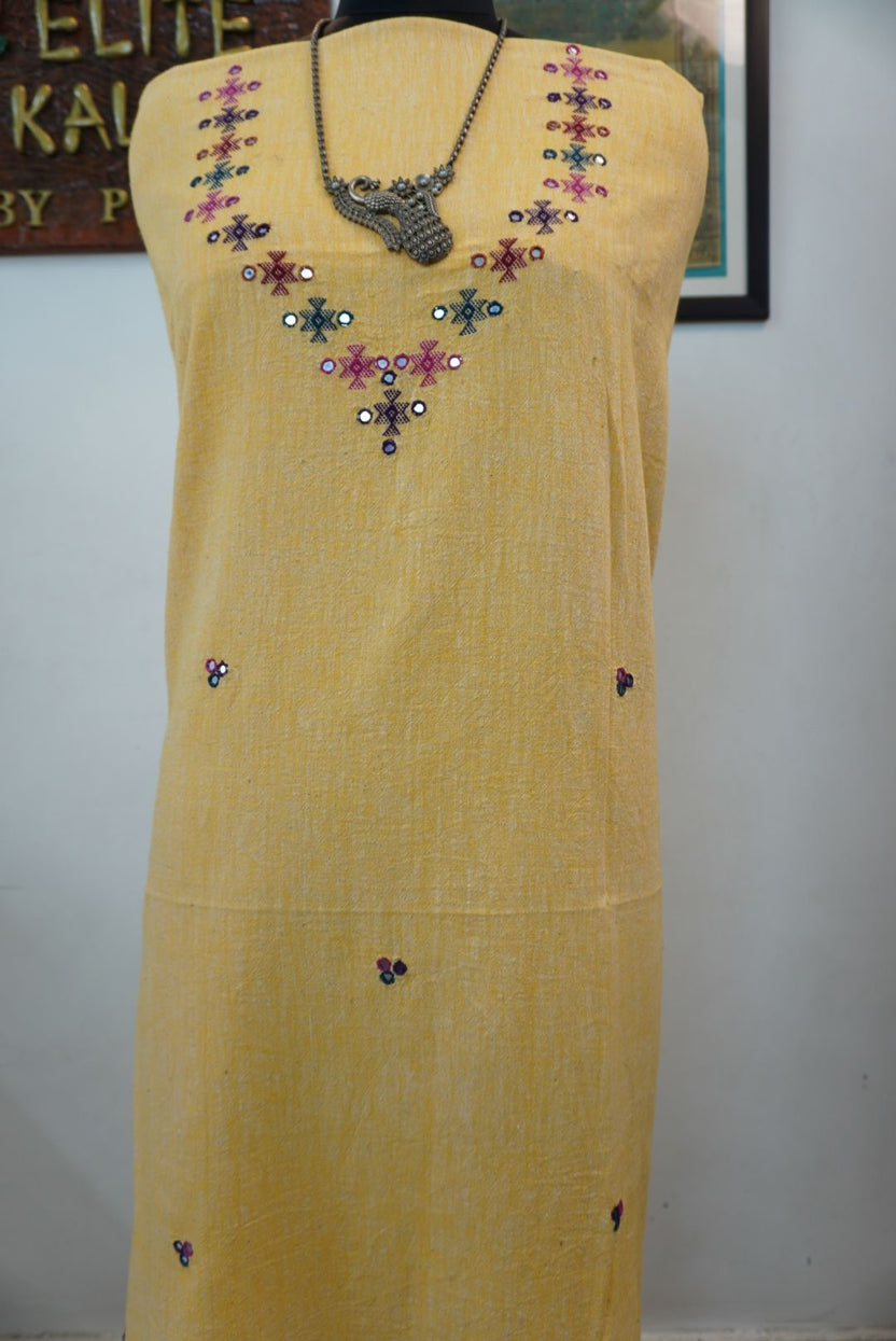Yellow kurti with neck chomuk design, placement pattern and visible mirror work