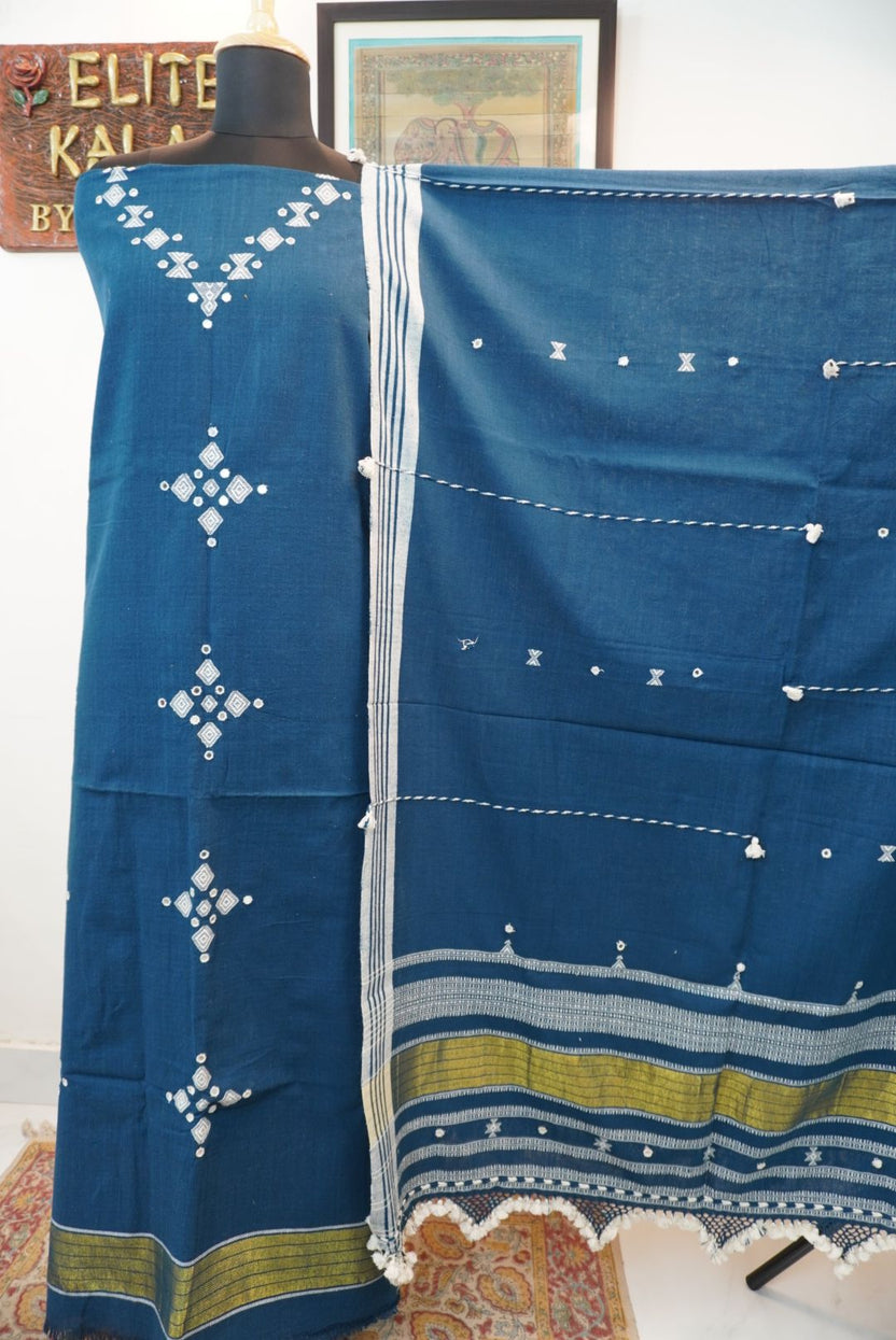 Teal blue 3 pc dress material with white and olive geometric design, border and tassels