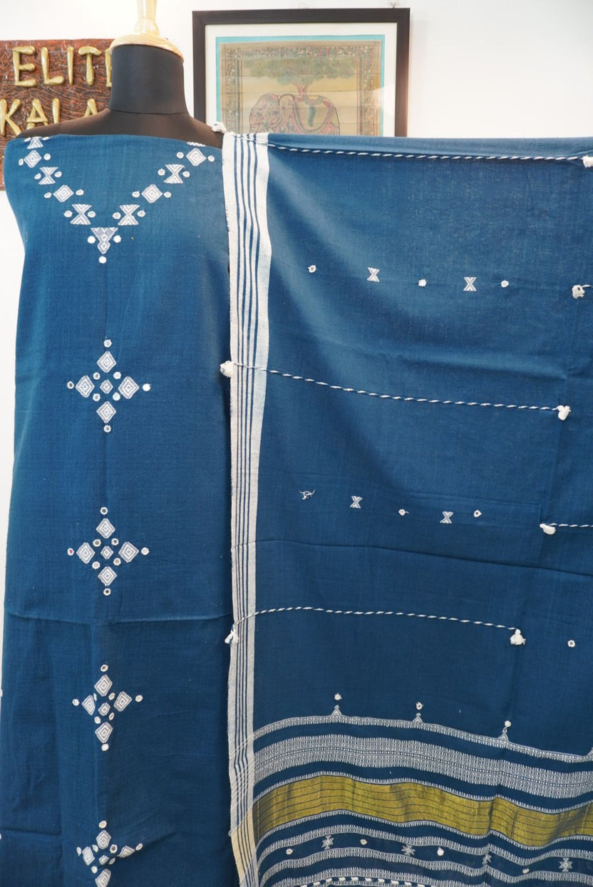 Teal blue 3 pc dress material with white and olive geometric design, border and tassels