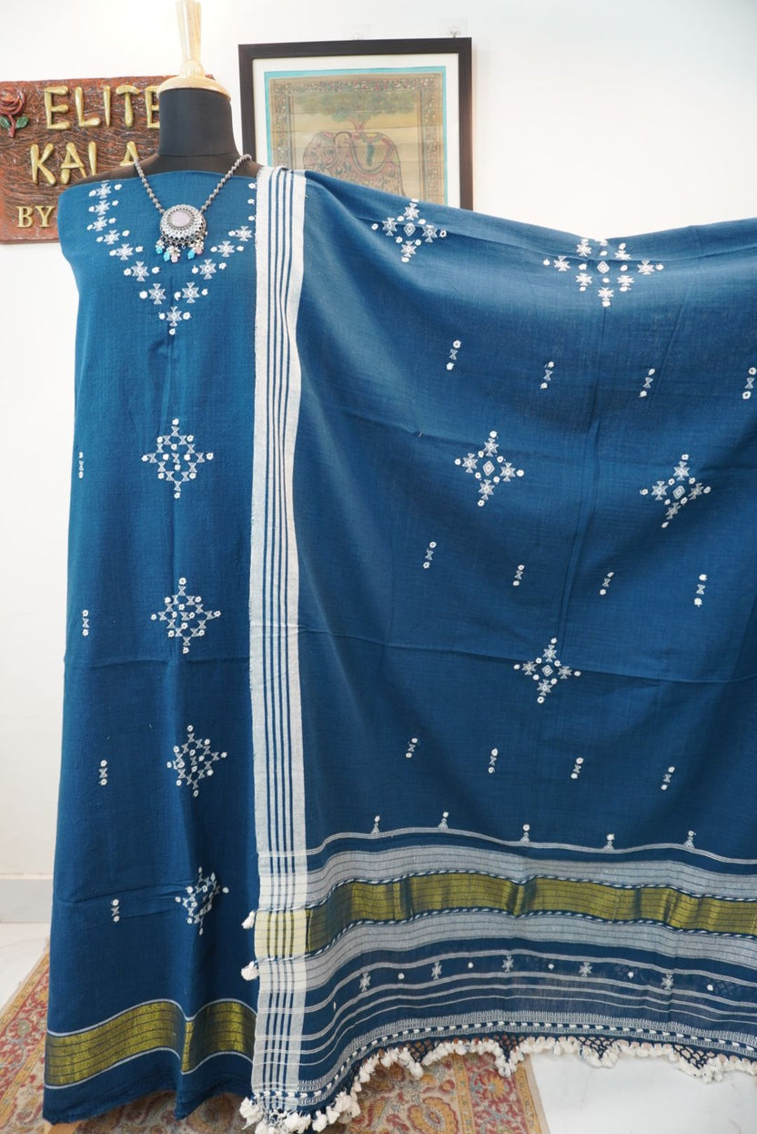Teal blue 3 pc dress material with geometric design, white and green accents, border, tassels and fringe