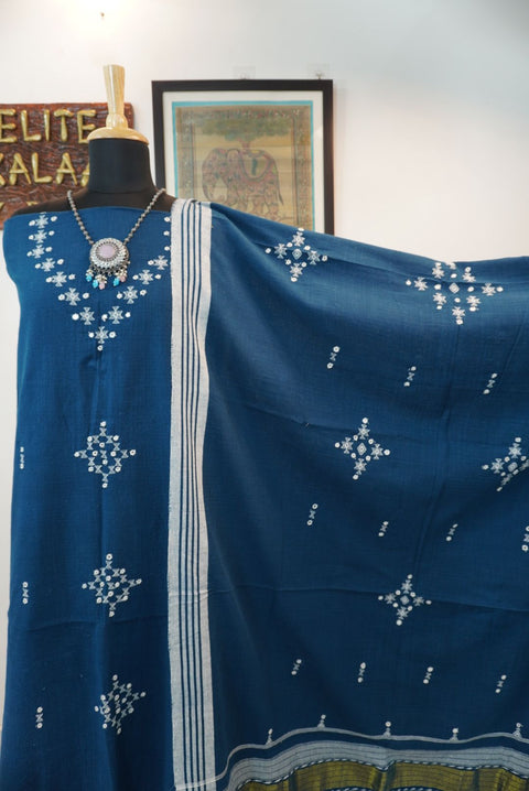 Teal blue 3 pc dress material with geometric design, white and green accents, border, tassels and fringe
