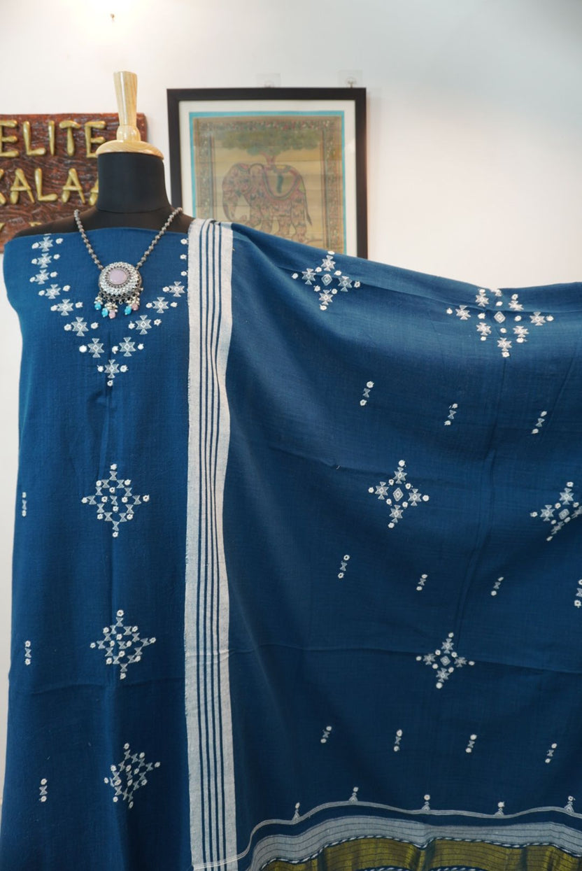 Teal blue 3 pc dress material with geometric design, white and green accents, border, tassels and fringe