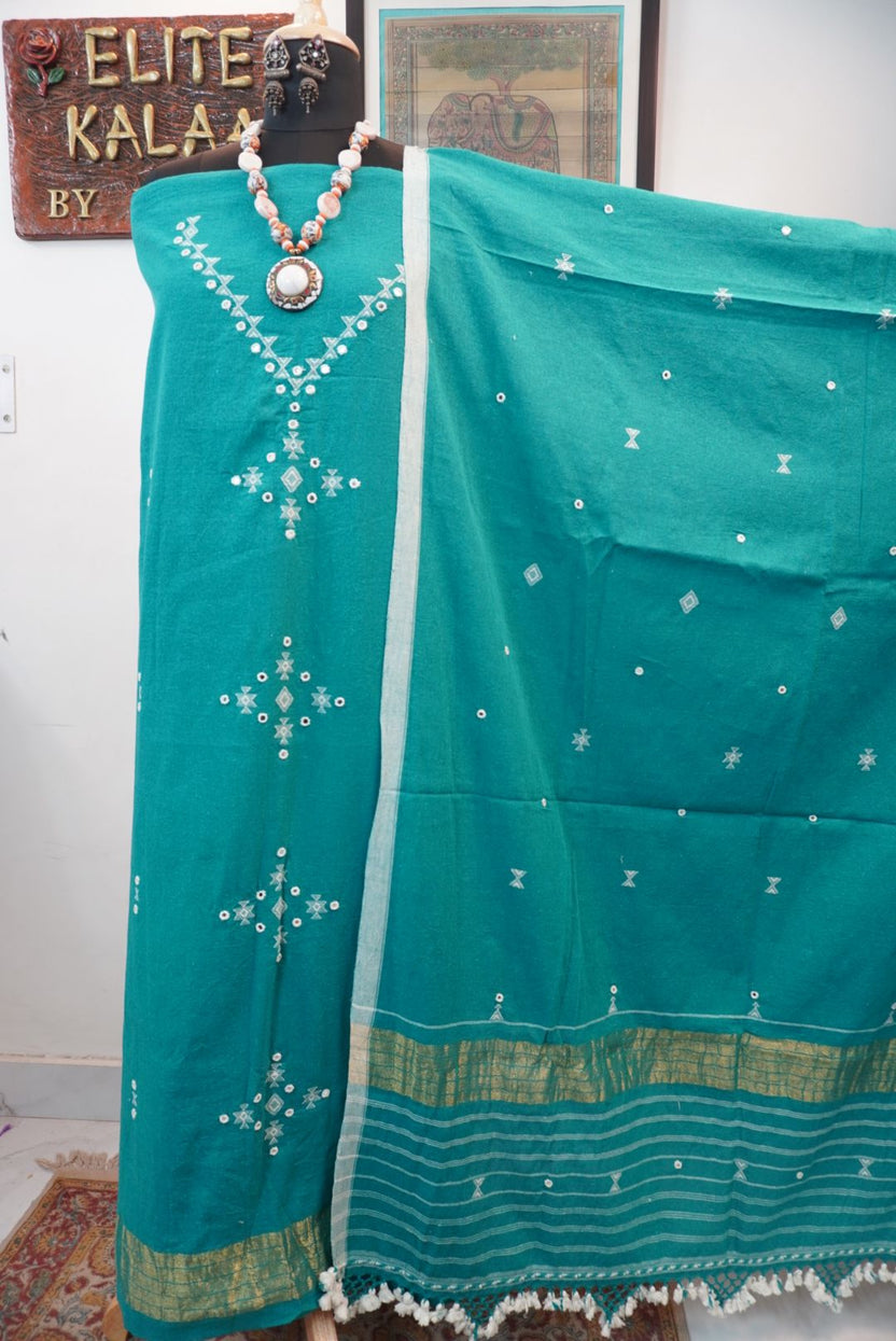 Green 3 piece dress material with placement pattern, border detail and tassels