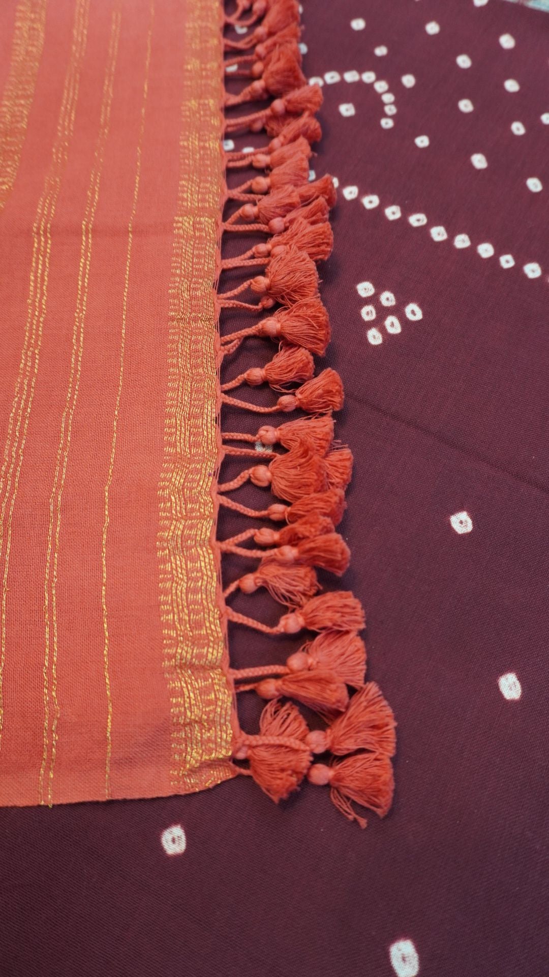 Ajrakh handblock bandhni 2 piece suit in carrot pink and maroon with border, tassels and zari detailing