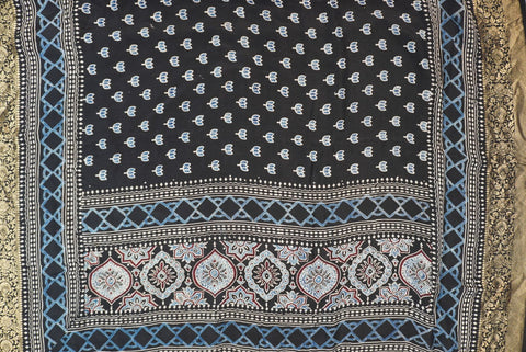 Black Dola silk Ajrakh handblock saree with all-over multicolor design, border and tassels
