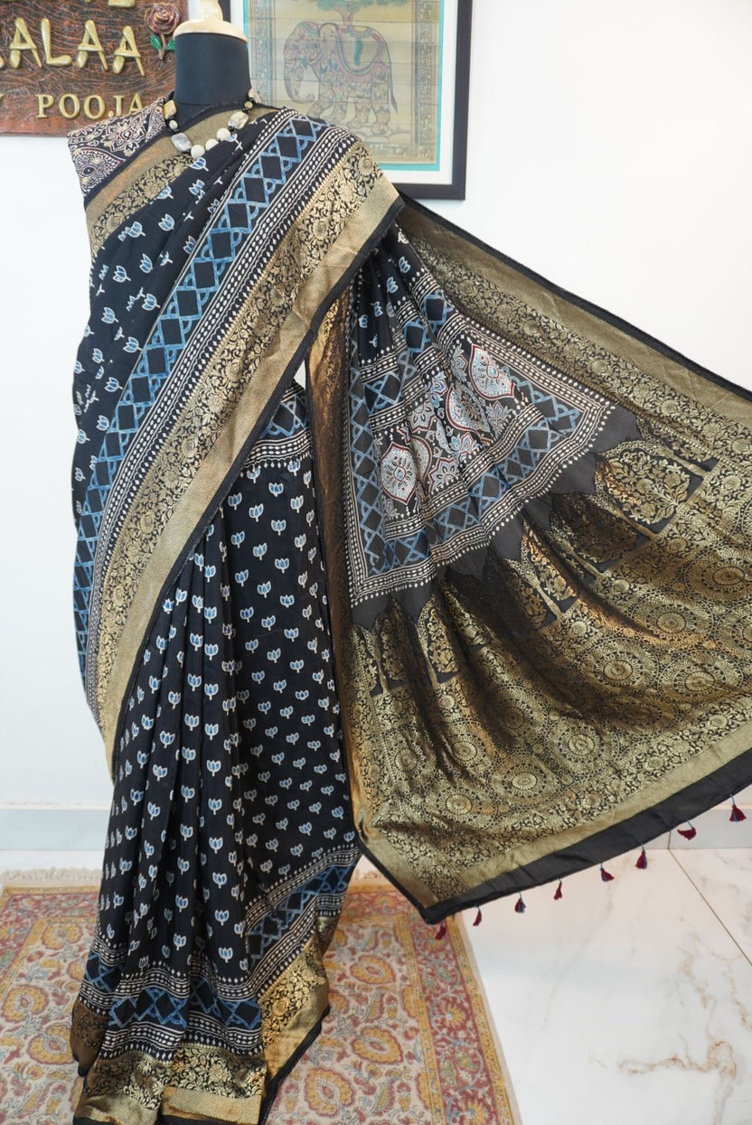 Black Dola silk Ajrakh handblock saree with all-over multicolor design, border and tassels