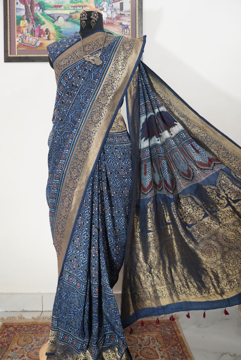 Dola silk Ajrakh saree in indigo blue with floral nakshi pallu, border, zari and thread tassels