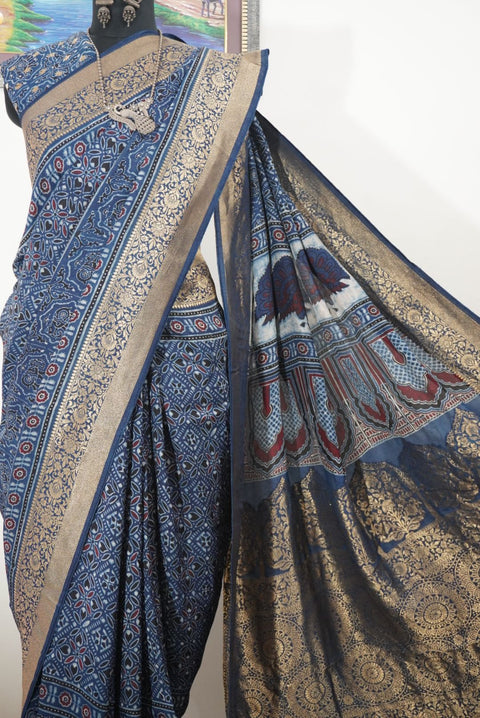 Dola silk Ajrakh saree in indigo blue with floral nakshi pallu, border, zari and thread tassels