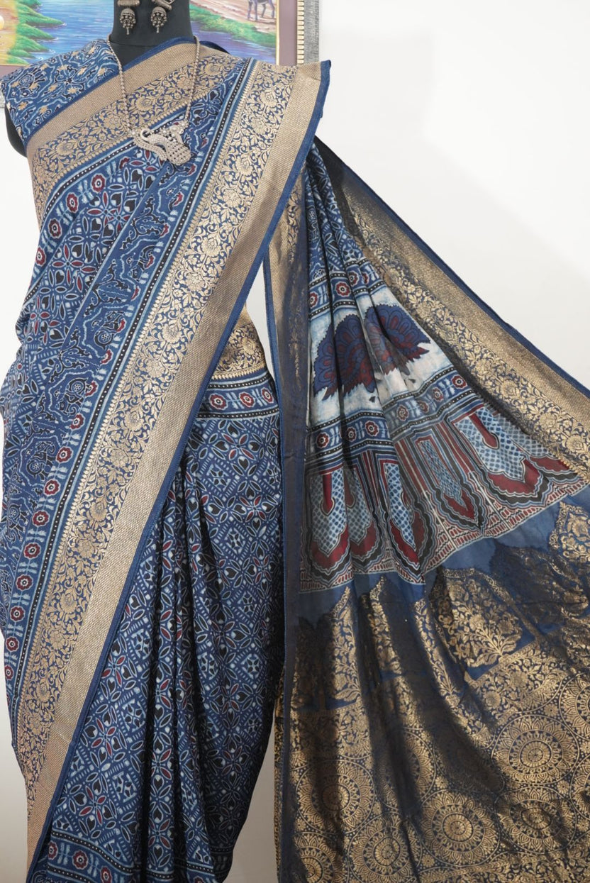Dola silk Ajrakh saree in indigo blue with floral nakshi pallu, border, zari and thread tassels