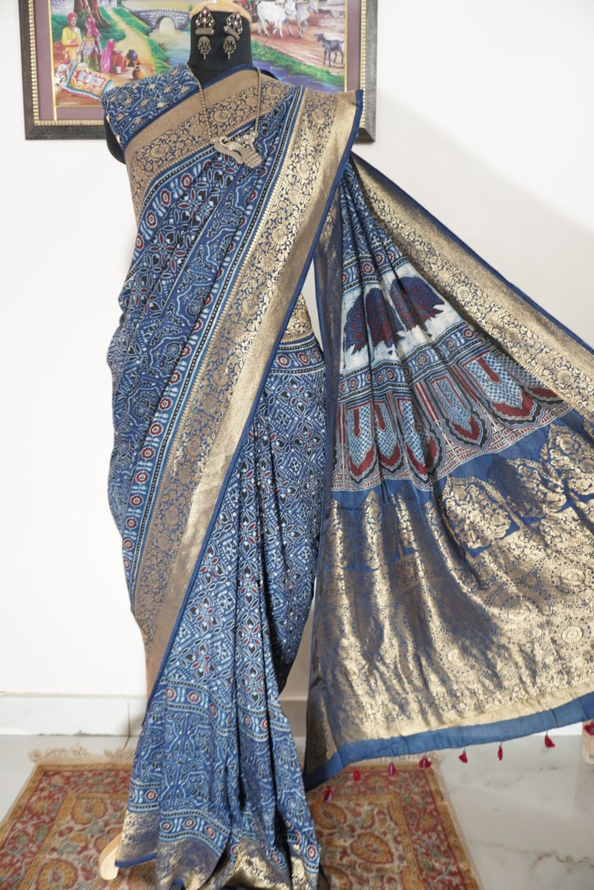 Dola silk Ajrakh saree in indigo blue with floral nakshi pallu, border, zari and thread tassels