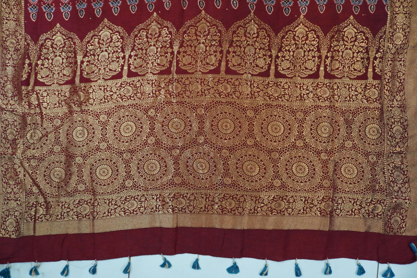 Red Dola silk saree with floral ajrakh pattern, multicolor detailing, border, zari accents and tassels