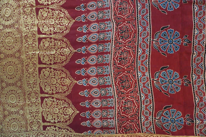 Red Dola silk saree with floral ajrakh pattern, multicolor detailing, border, zari accents and tassels