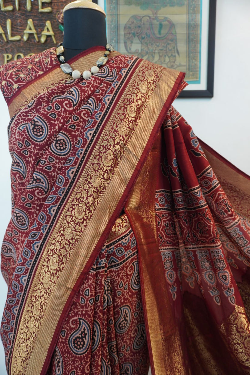 Red Dola silk saree with floral ajrakh pattern, multicolor detailing, border, zari accents and tassels