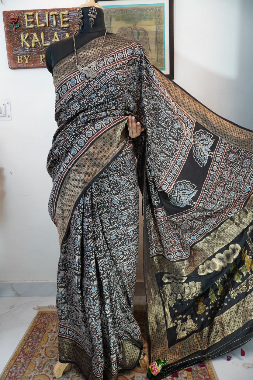 Black saree with all-over Ajrakh pattern in beige, blue and red, with border detail