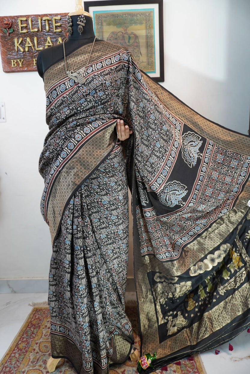Black saree with all-over Ajrakh pattern in beige, blue and red, with border detail
