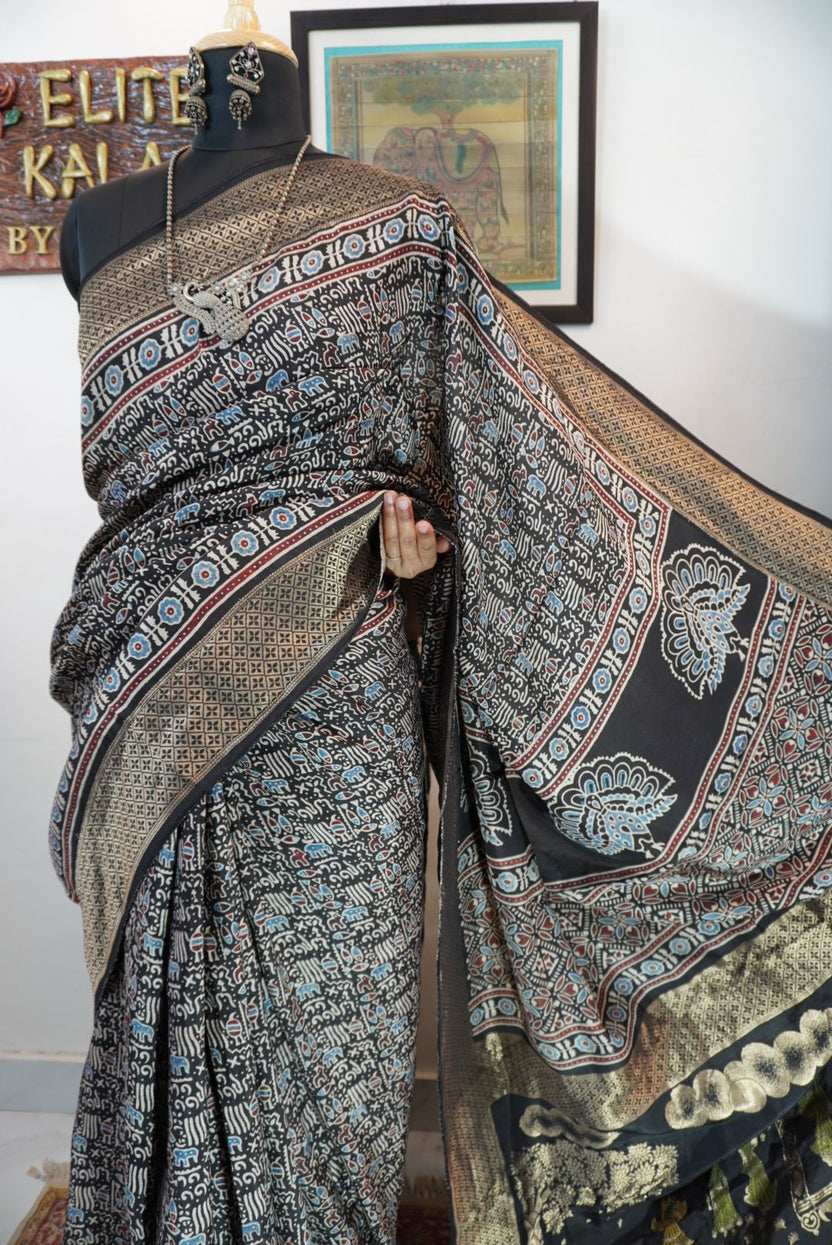 Black saree with all-over Ajrakh pattern in beige, blue and red, with border detail