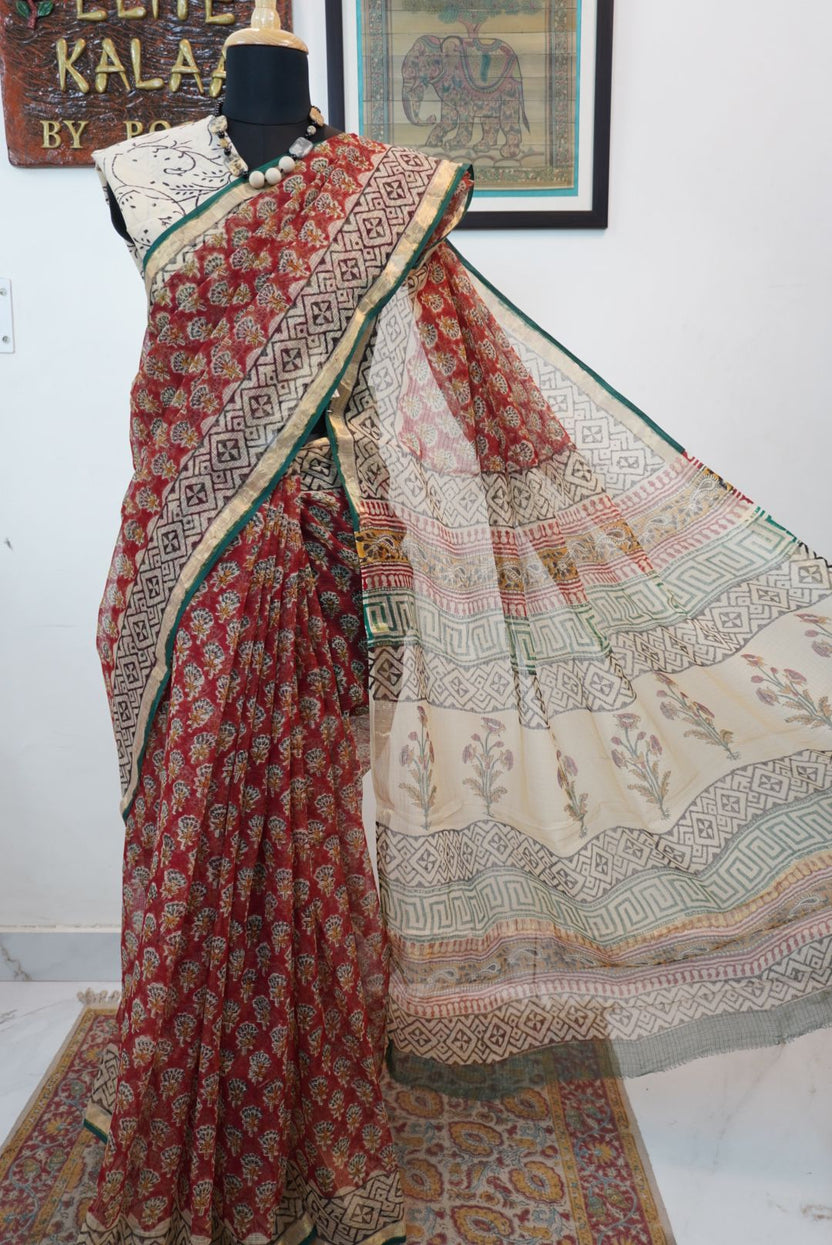 Red saree with multicolor block print and a visible border