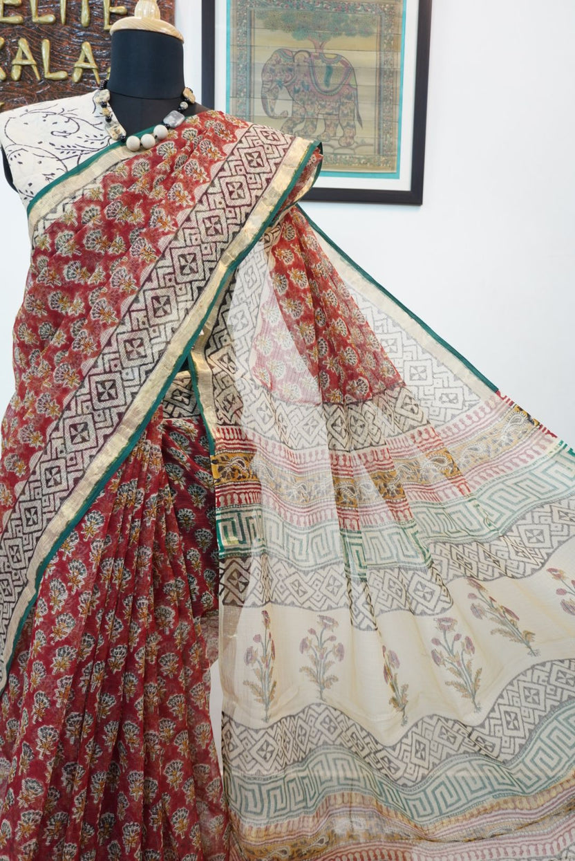 Red saree with multicolor block print and a visible border
