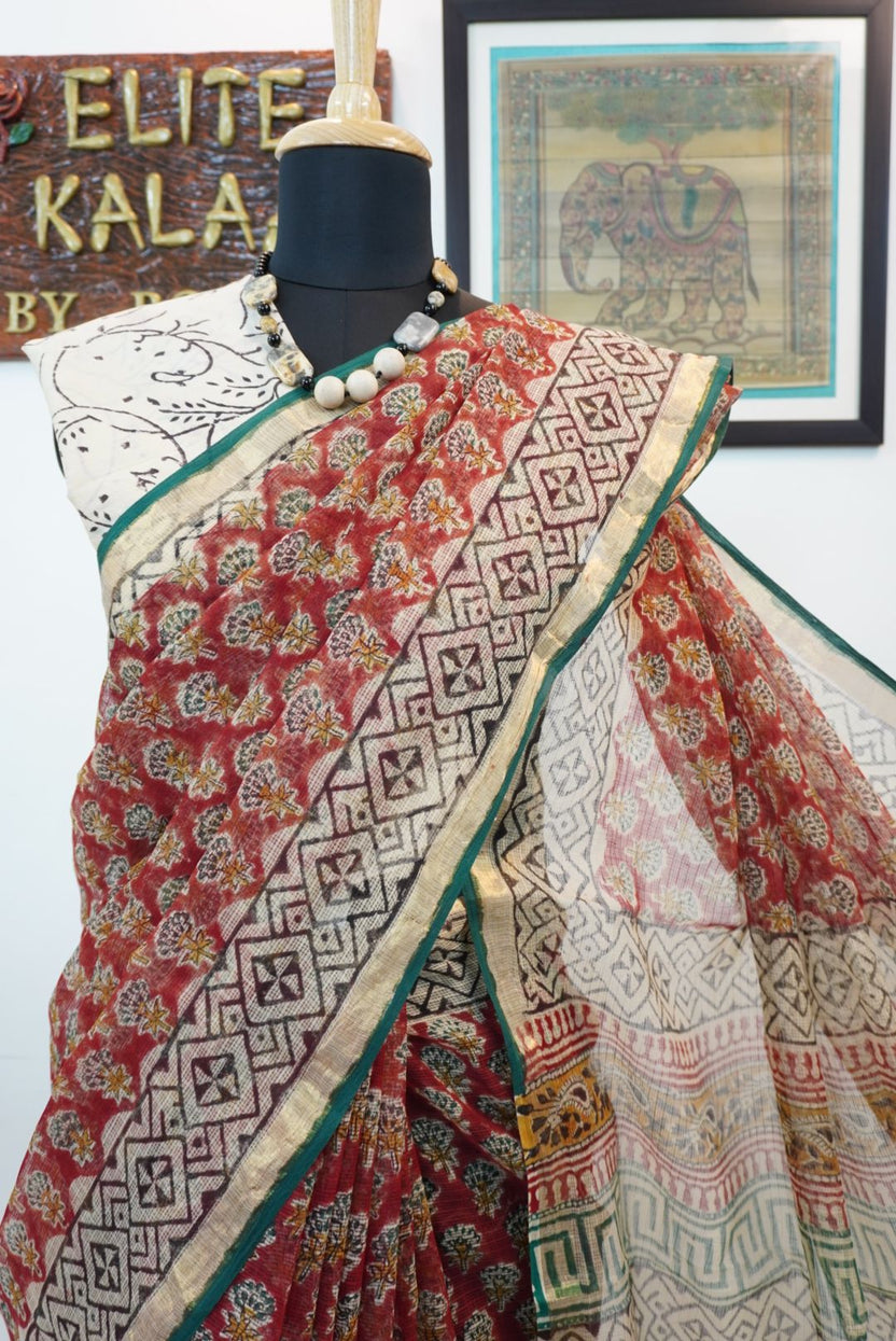 Red saree with multicolor block print and a visible border