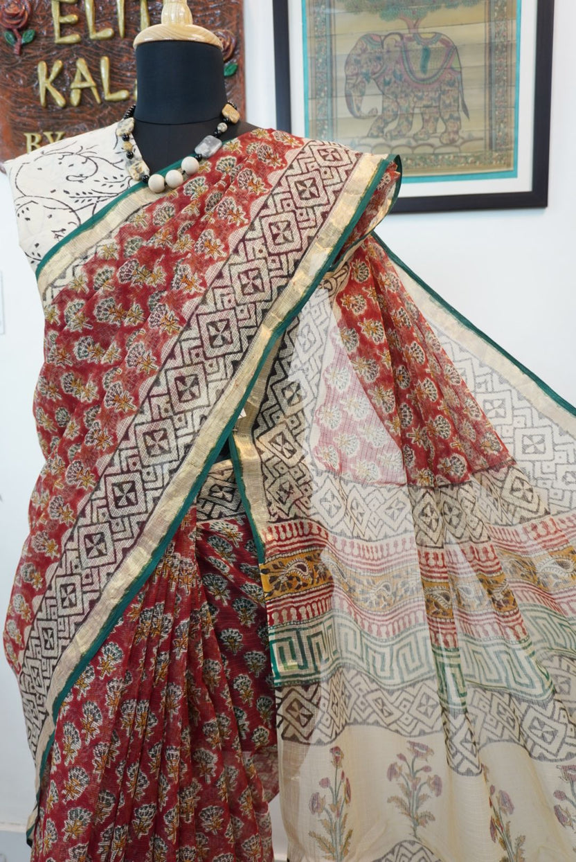 Red saree with multicolor block print and a visible border