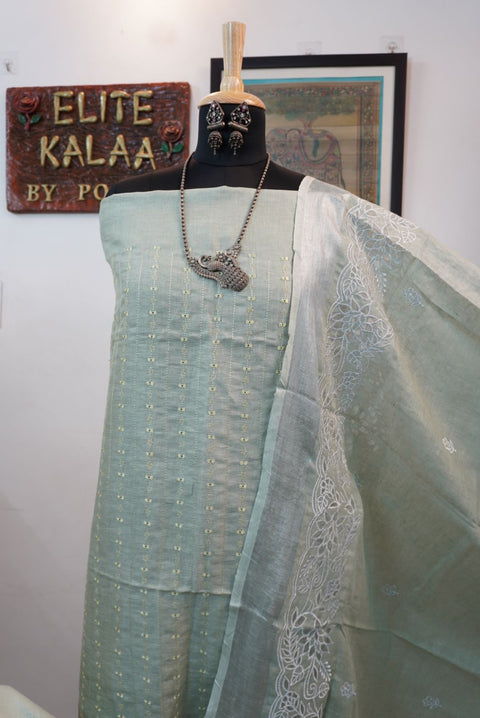 Light green linen 3 piece suit with white accents, applique work dupatta, border and tassels