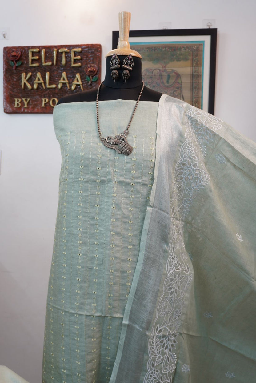 Light green linen 3 piece suit with white accents, applique work dupatta, border and tassels