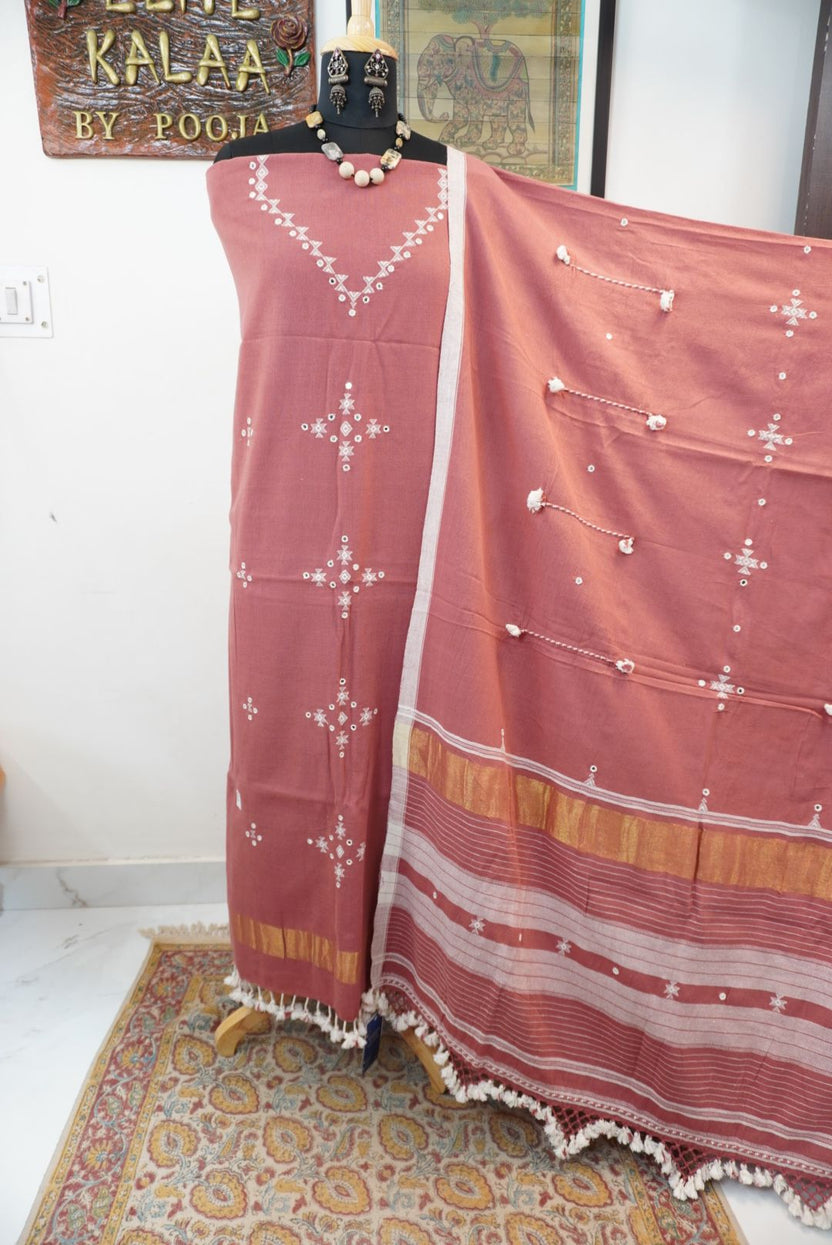 Bhujodi kala cotton suit in carrot pink with multicolor accents, border detailing and tassels