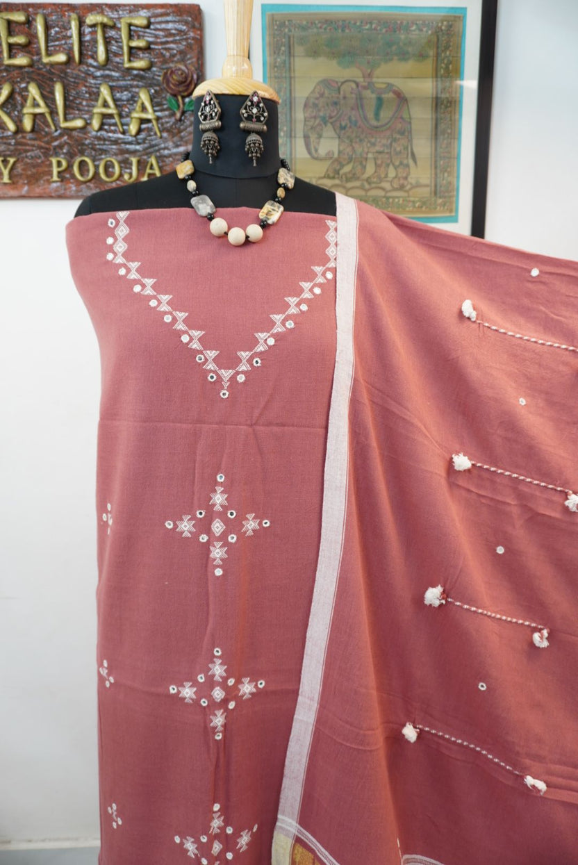 Bhujodi kala cotton suit in carrot pink with multicolor accents, border detailing and tassels